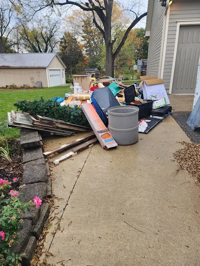 Dumpster being loaded with debris for Estate Cleanout Dumpster Rental in San Leon